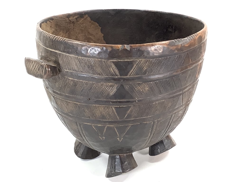 Nupe Carved Wood Vessel: 11 3/4"Dia., 11 1/2"H. Footed carved wood vessel with incised geometric design. Provenance: Collection of William and Diane Itter. Please see photos for condition and details.