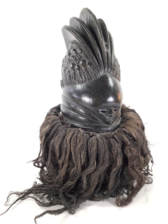 Mende Bundu Sowei Mask Sierra Leone: 15"H x 7"W 9 1/2"D. 23"H with hanging raffia hair. Hand-carved wood with fiber hair fringe. Good condition, natural wear consistent with age. Provenance: Collection of William and Diane Itter. Please 
