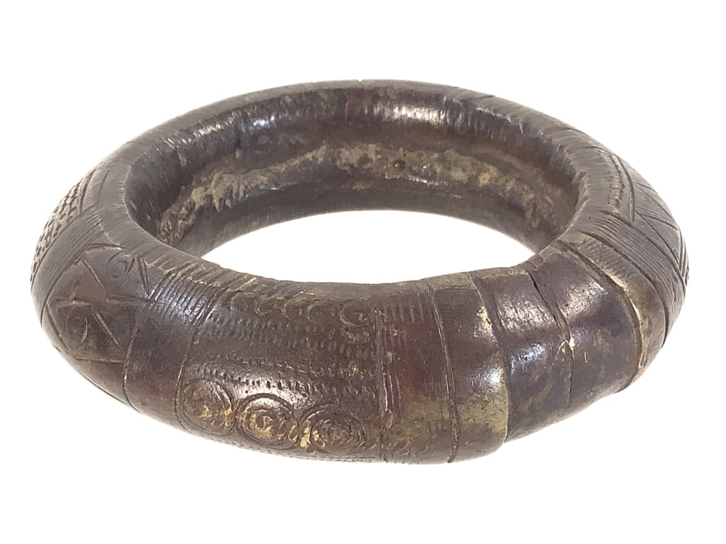 African Brass Currency Bracelet: 4 1/8"Dia. Provenance: Collection of William and Diane Itter. Please see photos for condition and details.