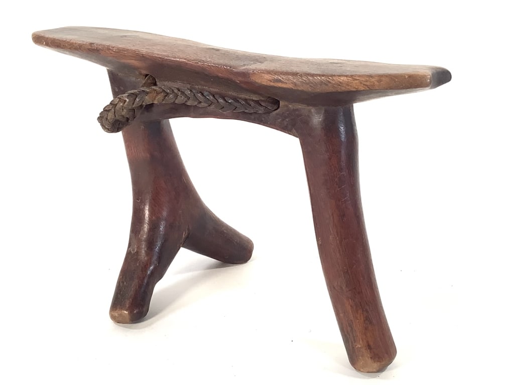 Dinka or Gurage Head Rest S Sudan / Ethiopia: 9 5/8"L x 4 1/2"W x 6 1/2"H. Carved wood with braided leather handle. Fissures on right back leg. Provenance: Collection of William and Diane Itter. Please see photos for condition and details.