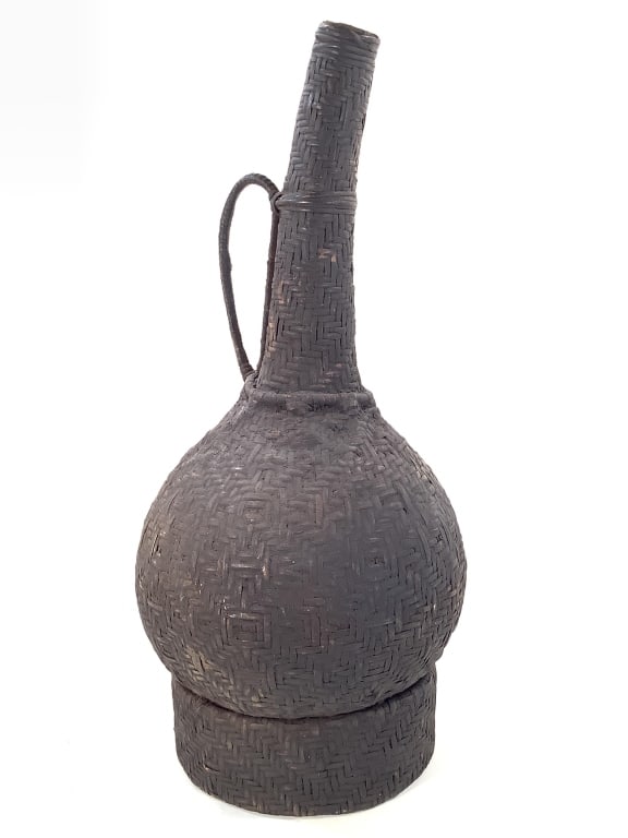 Cameroon Grasslands Palm Oil Basket Over Gourd: 20"H. 7 1/2"Dia. at the bottom base. Basketry with handle over gourd with dark surface pigmentation added to the surface. Provenance: Collection of William and Diane Itter. Please see photos for
