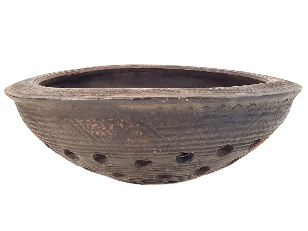 Nupe Perforated Ceramic Pot Nigeria: 14 3/8"Dia, 5 3/8"H. Ceramic Bowl with 5/8" holes and geometric design on the top edge and bottom. Provenance: Collection of William and Diane Itter. Please see photos for condition and details.