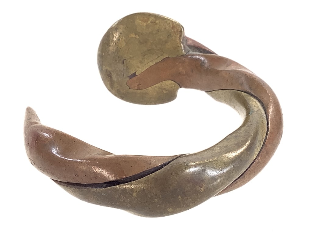 West African Twisted Currency Bracelet: 3" x 3". Copper alloy and brass. Provenance: Collection of William and Diane Itter. Please see photos for condition and details.