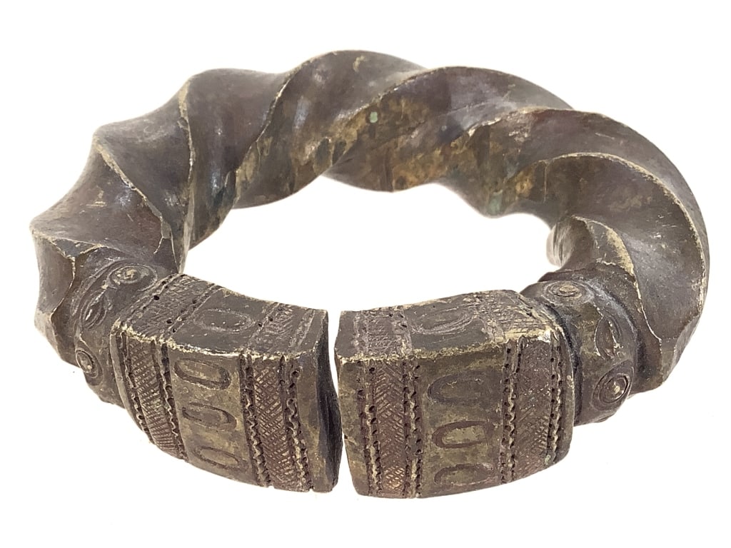 West African Twisted Currency Bracelet: 4" x 3 5/8". Provenance: Collection of William and Diane Itter. Please see photos for condition and details.