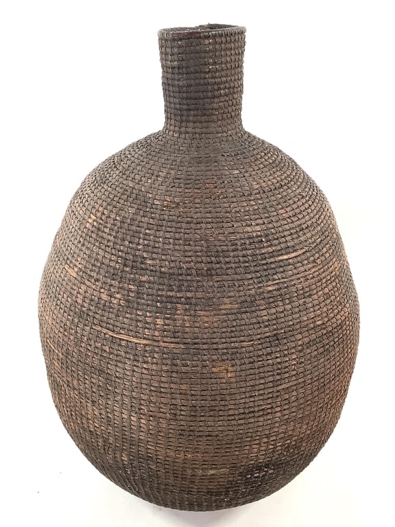 Cameroon Grasslands Basketry Vessel: 14 1/2"Dia x 21"H. Large dense coiled weaved ovoid basket with short neck. Provenance: Collection of William and Diane Itter. Please see photos for condition and details.
