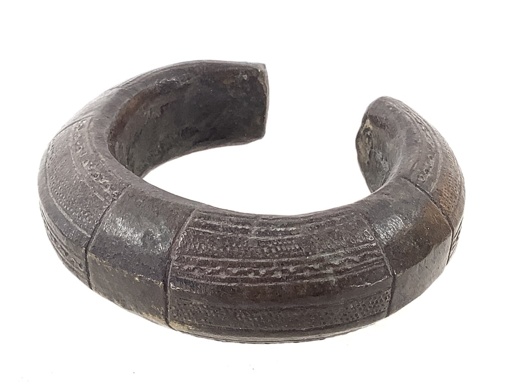West African Currency Bracelet: 3 5/8" x 3 3/8". Provenance: Collection of William and Diane Itter. Please see photos for condition and details.