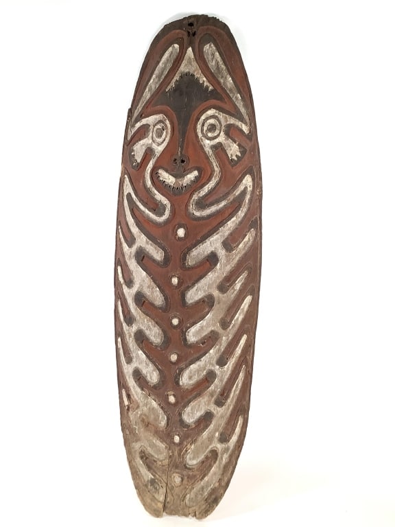 Gope Board Papuan Gulf Papua New Guinea: 41"H x 13"W. Carved hardwood. Fair condition, natural wear consistent with age. Crack at base and at right side, surface wear and loss at top and bottom edge. Provenance: Collection of William and