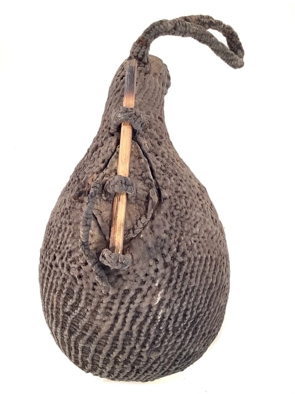 Woven Vessel Cameroon Grasslands: 12 1/4"H x 7"Dia. A striking hand-crafted piece from Cameroon, raffia fibers woven over a clay core. Fair condition with natural wear consistent with age and use. Provenance: Collection of William