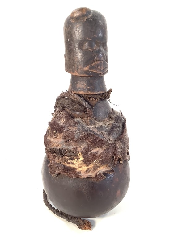 Figural Medicinal Gourd: 9 3/4"H x4 5/8"Dia. East Africa. Wood and gourd container with carved wood stopper and animal fur at center. Fair condition with natural wear consistent with age and use. Provenance: Collection of