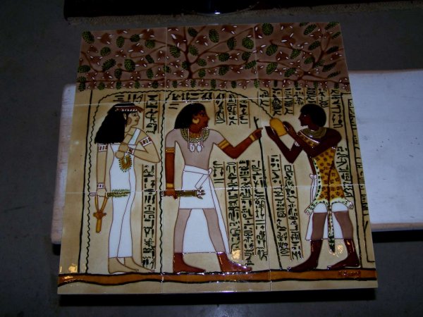 Handpainted porcelain tiles.: Images of ancient Egyptian figures and hieroglyphics in colors of browns, gold, green, white.