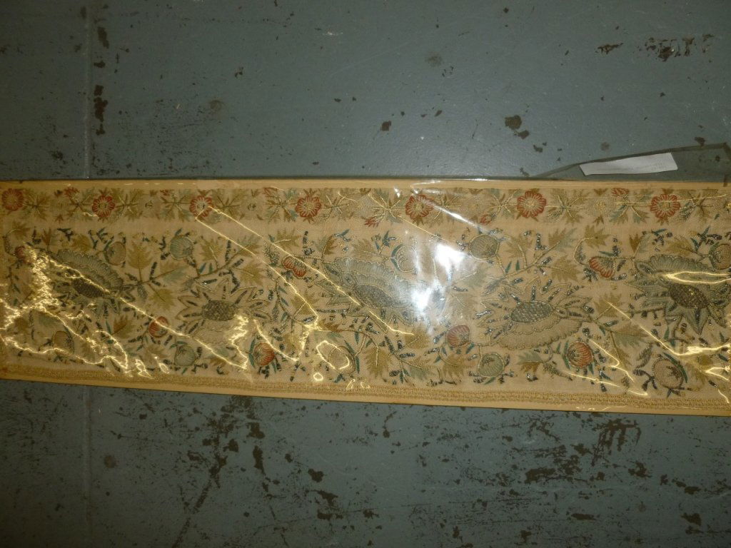 Antique Turkish Embroidery from 1850: A genuine piece of antique embroidery from Turkey in 1850. The rare embroidery is intricate with flowers and beading. 32" x 9.5". It's mounted on a paper backing, in a plastic sleeve.