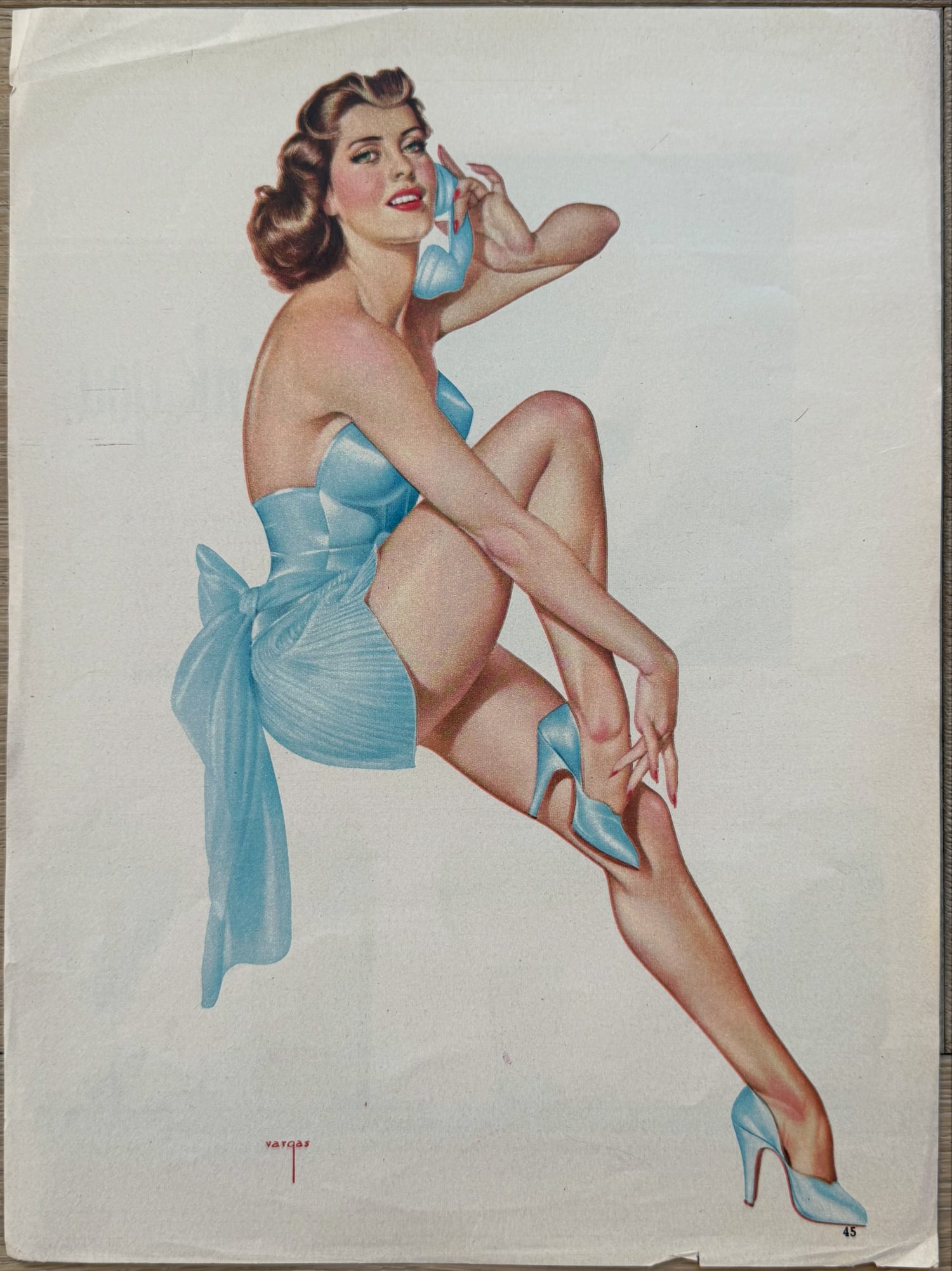 Alberto Vargas Esquire Magazine Artist Proof November 1944: This is an artist proof/magazine clipping of a brunette in blue with phone for Esquire Magazine November 1944.