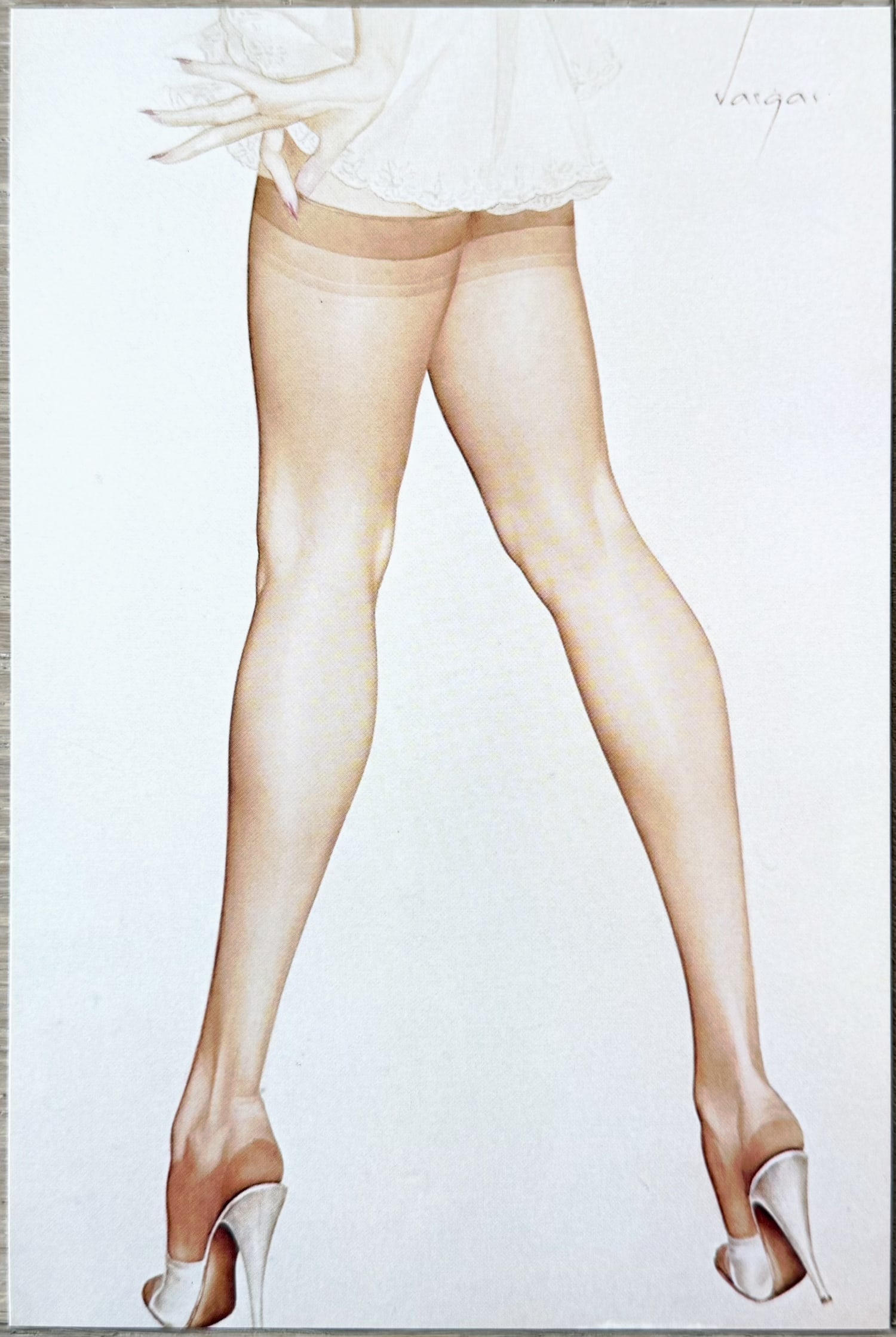 Alberto Vargas Pin-Up “Legs in Sheer Stockings?? 1979 Postcard: A elegant Vargas Girl leg study featuring a stunning blonde in sheer stockings and white high heels. The view highlights her long, shapely legs in a graceful standing pose, with a delicate white lace-