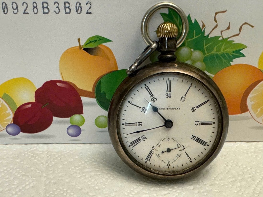 This antique Seth Thomas pocket watch features bold Roman numerals: This antique Seth Thomas pocket watch features bold Roman numerals, a subdial, and a classic patina. Its back showcases a rare engraved horse and rider, adding unique historical charm.