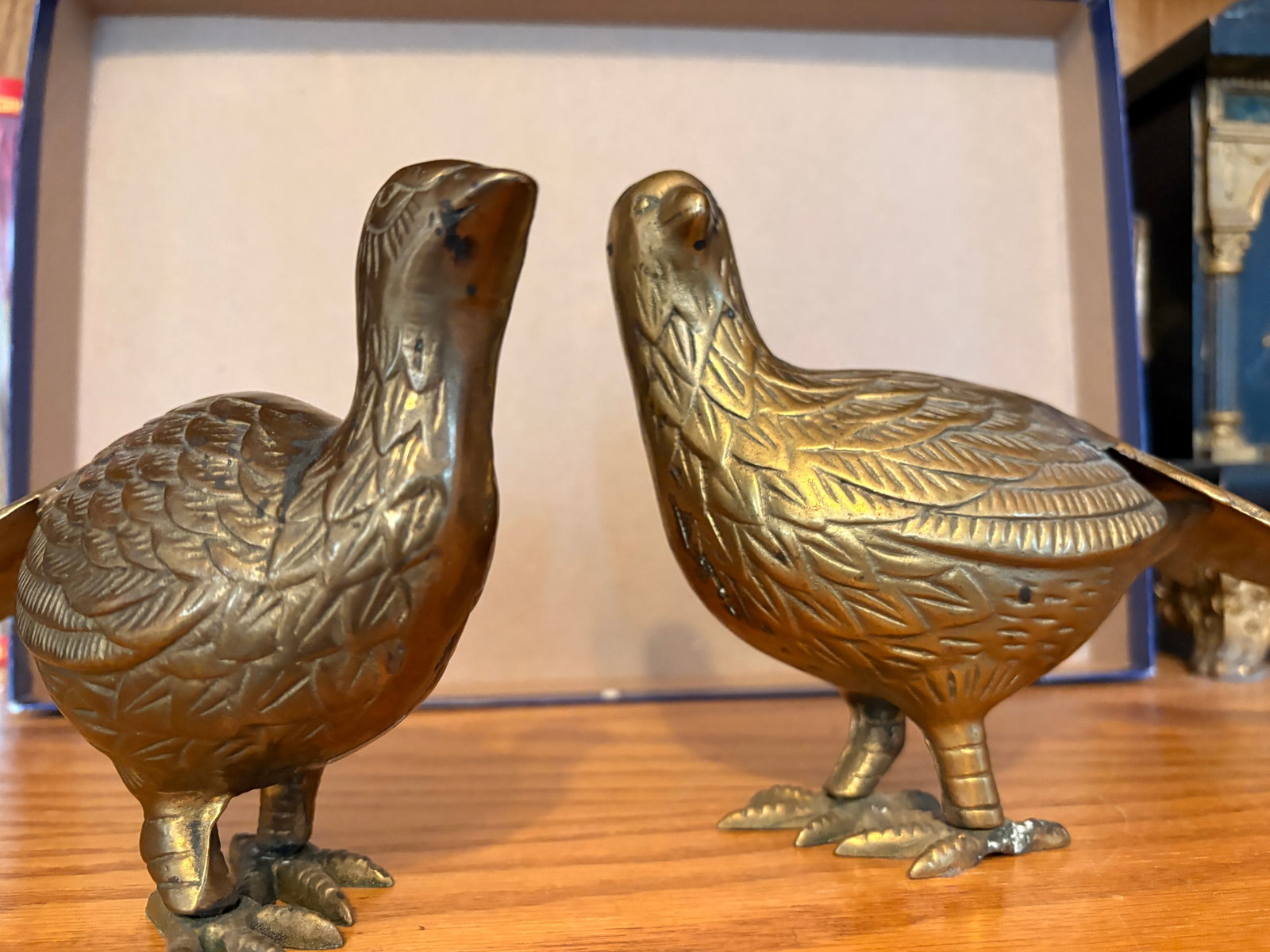 Pair of Vintage Brass Pheasant Figurines: A matched pair of vintage cast brass pheasant figurines, finely detailed with textured feathers, elongated tails, and expressive stance. Warm aged patina throughout with natural wear consistent with