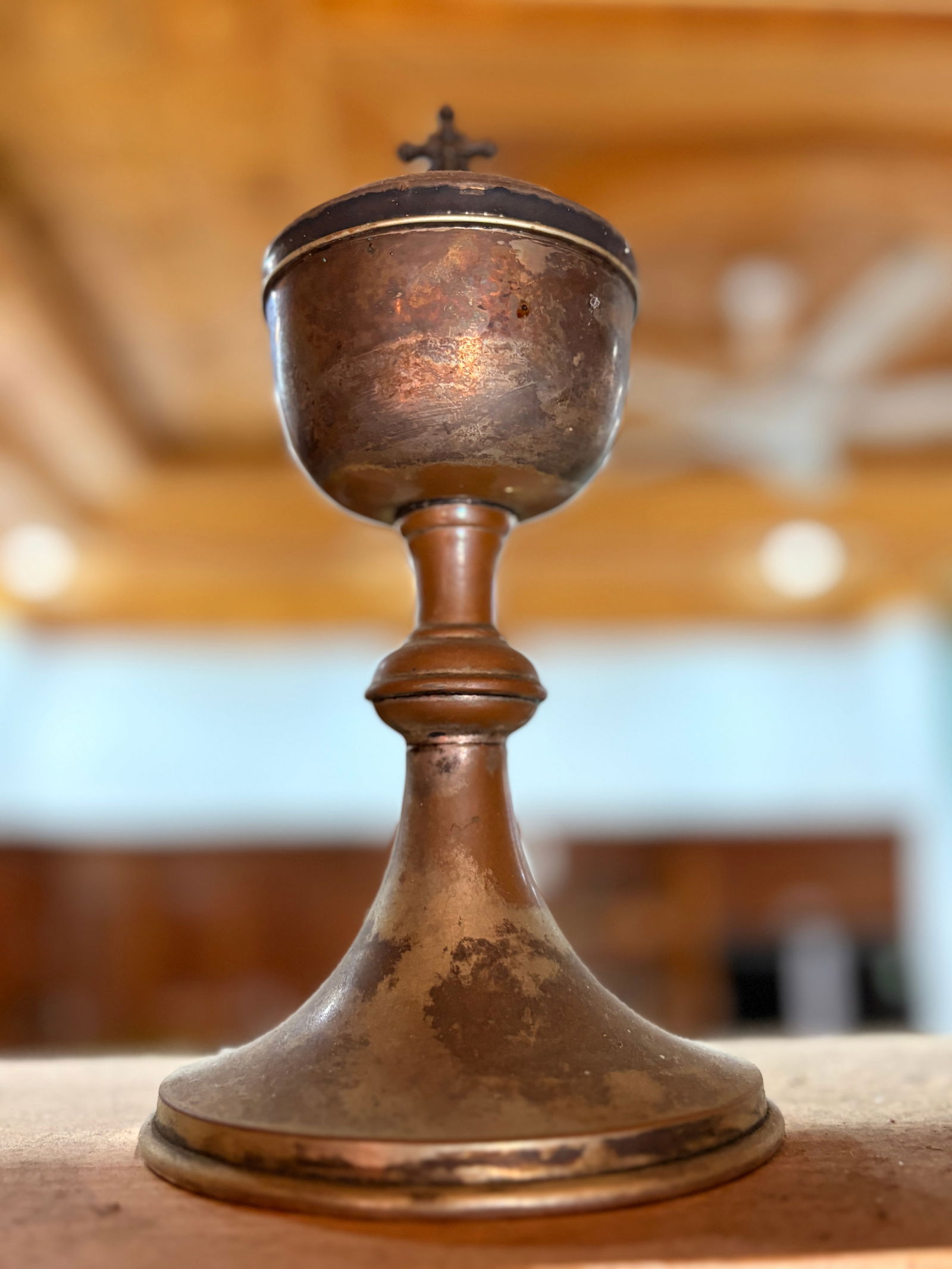 Vintage Lidded Communion ciborium with Cross Finial: Vintage metal communion vessel with domed lid and cross finial. Interior cup retains bright gold-tone finish; exterior shows aged patina consistent with use. Suitable for liturgical use, devotional