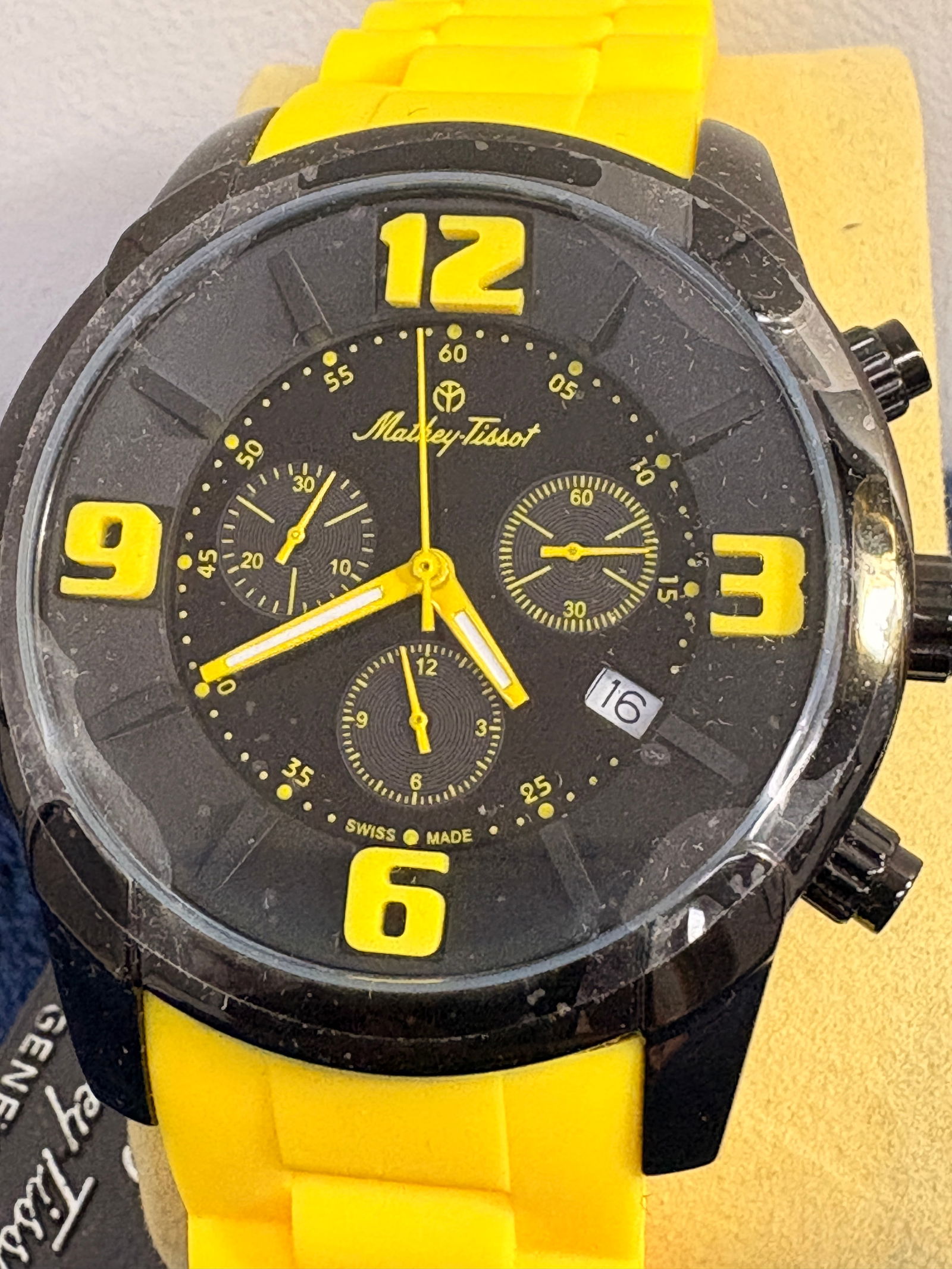 Mathey-Tissot Chronograph Wristwatch: Mathey-Tissot Swiss Made chronograph featuring a black dial with bold yellow numerals and hands, date at 4 o’clock, and yellow silicone strap. Multi-subdial sport design in black-tone case. Case