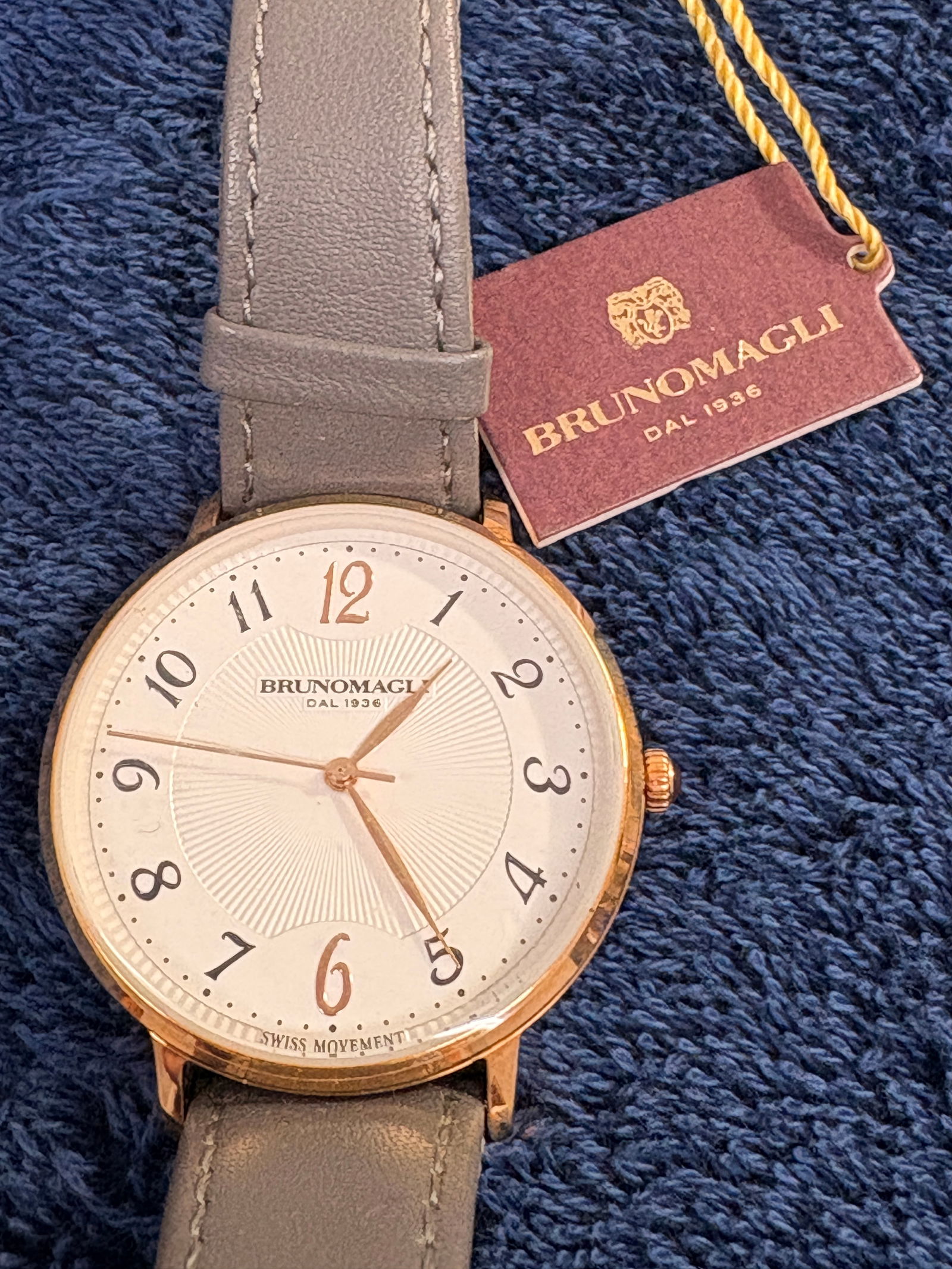Bruno Magli Roma 1221 Swiss Made Gold-Tone Dress Watch: Elegant Bruno Magli Roma 1221 dress watch featuring Swiss quartz movement, gold-tone case, and genuine leather strap. Water resistant to 50 m. Appears new old stock with original tag attached. A