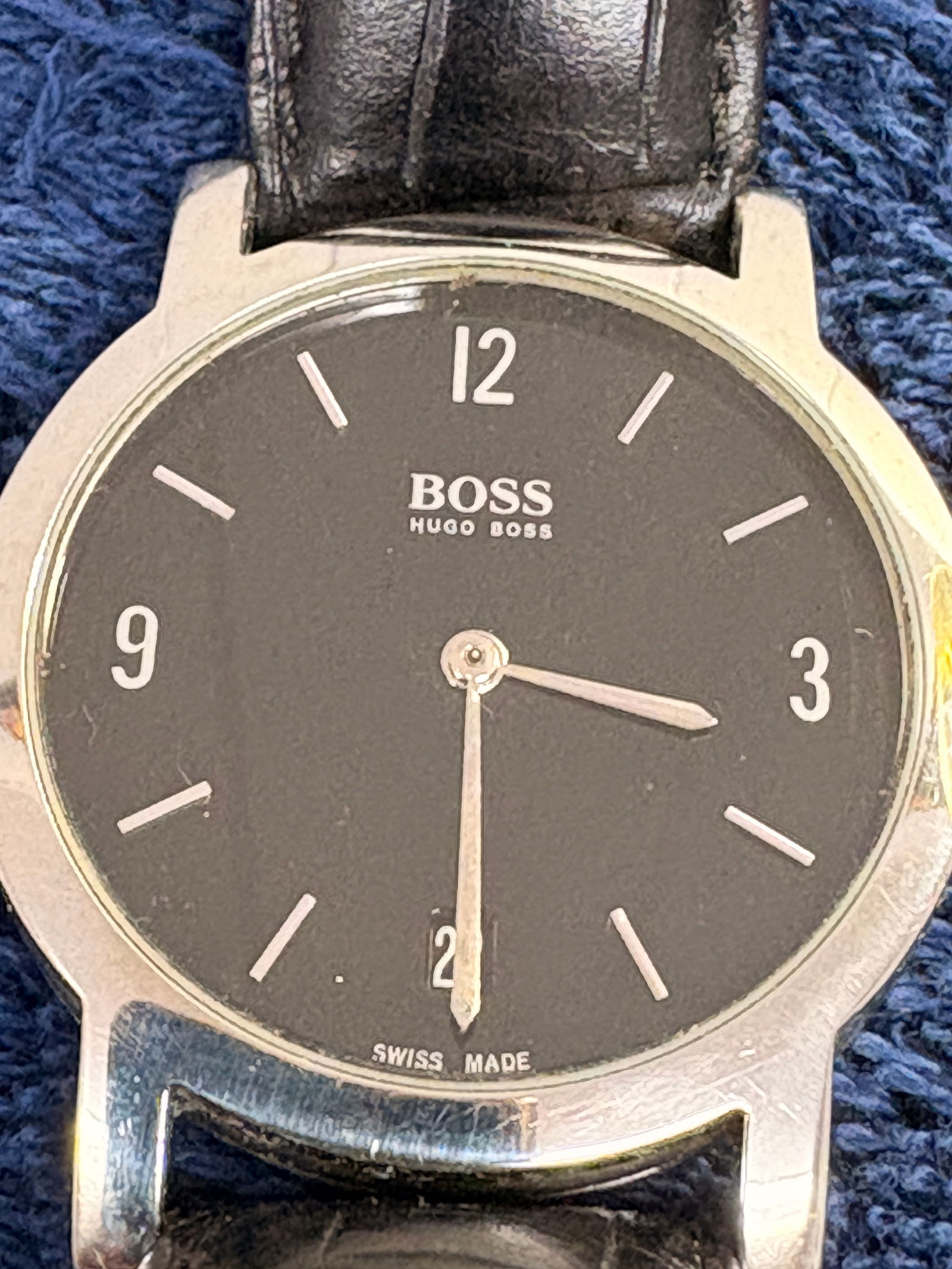 Hugo Boss Swiss Made Quartz Wristwatch: Sleek Hugo Boss wristwatch featuring a black minimalist dial, silver-tone stainless steel case, and genuine leather strap. Swiss Made quartz movement; approx. 36 mm case. Light wear, running