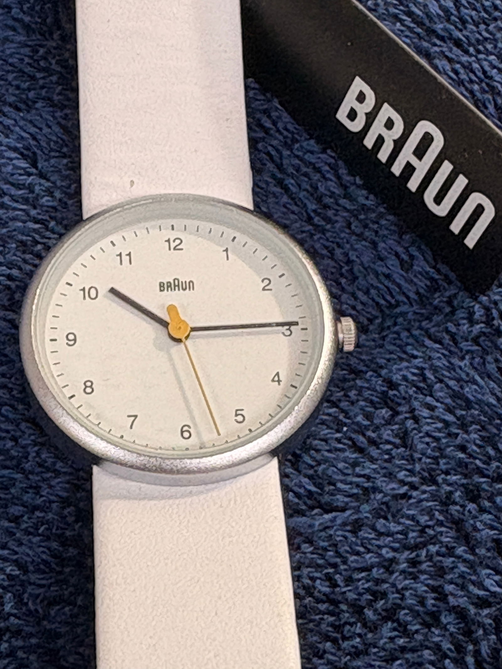 Braun BN0231 Minimalist Designer Watch: Iconic Braun minimalist wristwatch (model BN0231WHWHLAL) with clean white dial and yellow seconds hand. Stainless steel case and white strap. Quartz movement. Light wear; running condition is