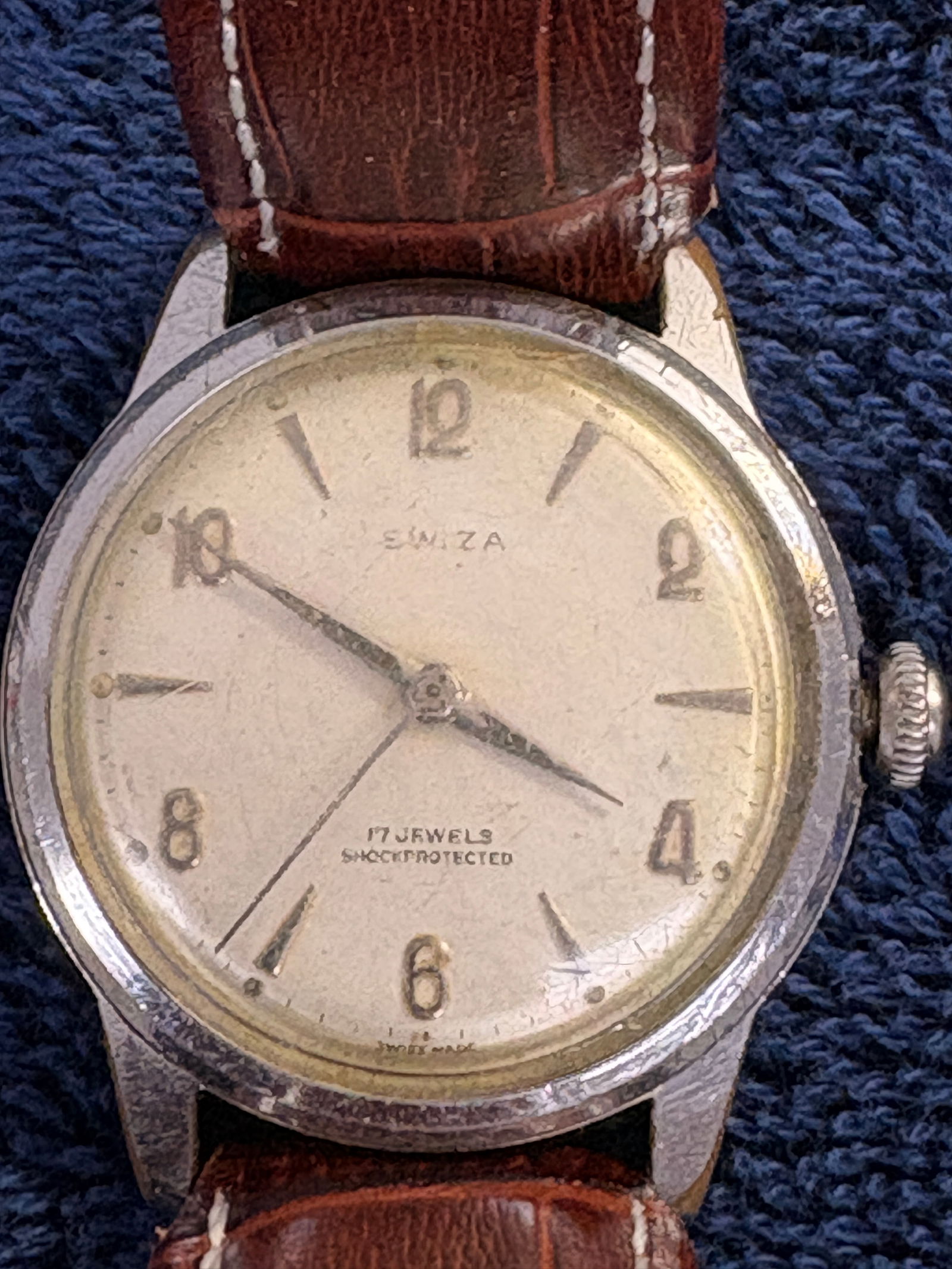 Vintage Swiza 17 Jewels Shockprotected Swiss Wristwatch: Classic mid-century Swiza manual-wind watch featuring a clean Arabic numeral dial, 17 jewels movement, and shockprotected Swiss construction. Nicely sized vintage case with warm patina and fitted leat