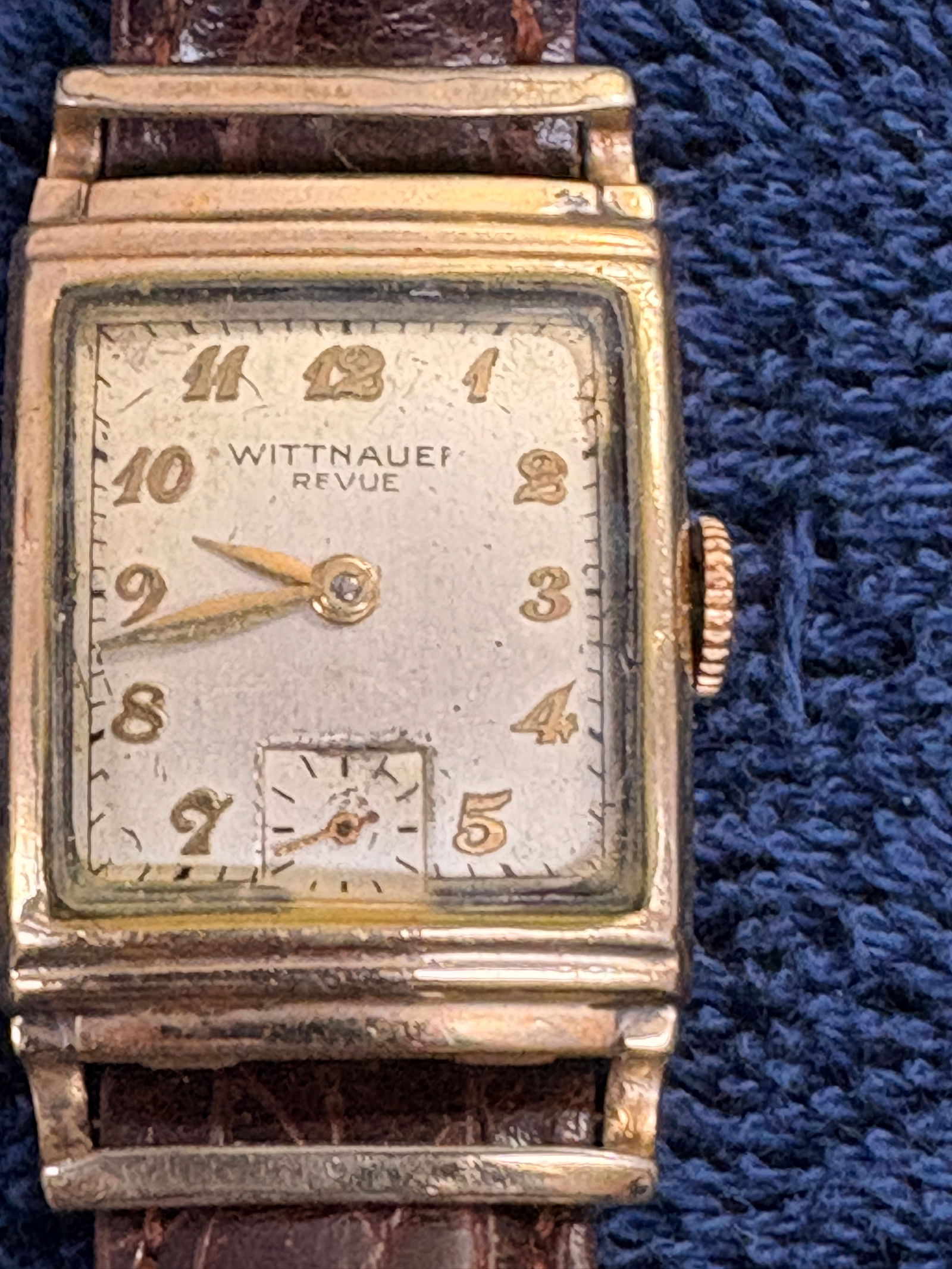 Wittnauer Revue Art Deco Tank Watch: Vintage rectangular manual-wind wristwatch by Wittnauer Revue featuring classic Art Deco styling, cream dial with Arabic numerals, and small seconds subdial at 6 o’clock. Gold-tone case shows