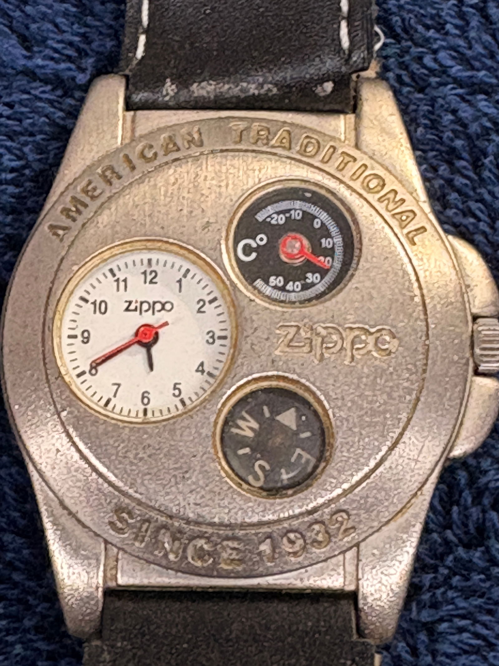 Zippo Multi-Function Quartz Wristwatch (Compass & Thermometer): Vintage Zippo novelty wristwatch featuring integrated compass and Celsius thermometer sub-dials, plus analog quartz time display. Stainless steel back, marked “Since 1932” and licensed by