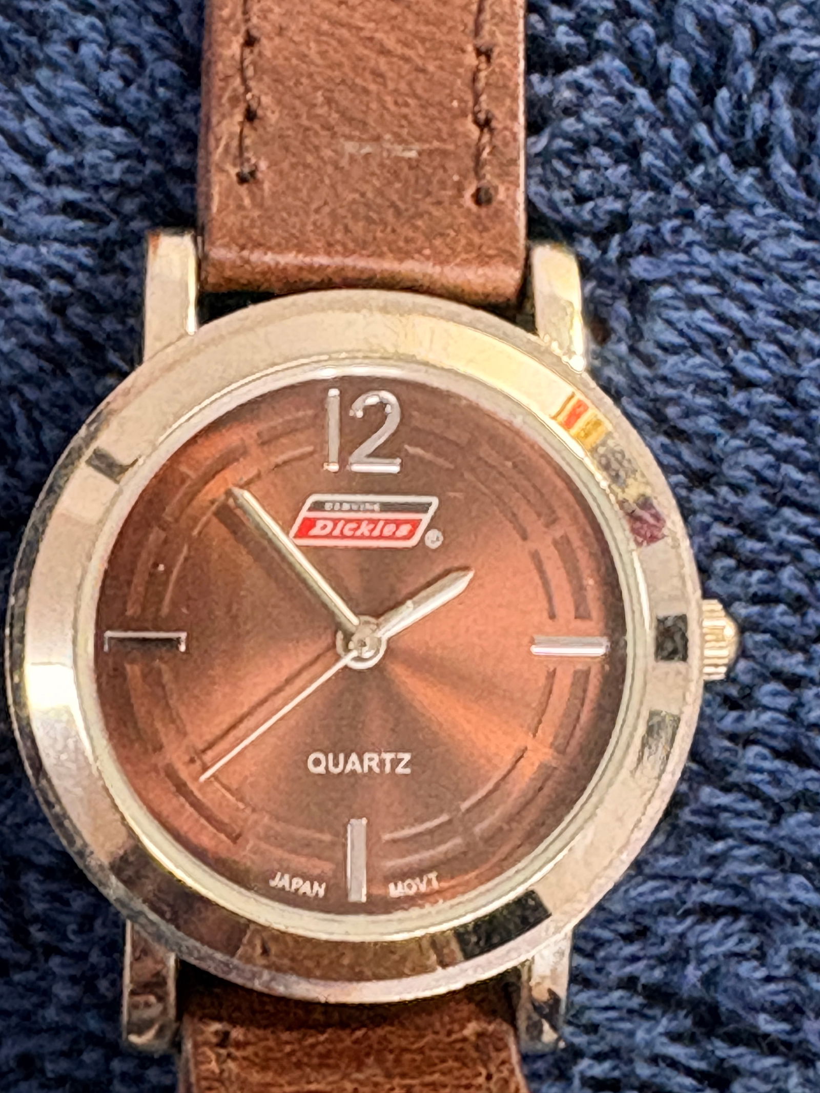 Dickies Quartz Watch (Brown Dial, Leather Strap): Casual Dickies quartz wristwatch with warm brown sunburst dial and genuine leather strap. Japan movement noted on dial. Case shows light wear; strap exhibits normal use. A practical everyday