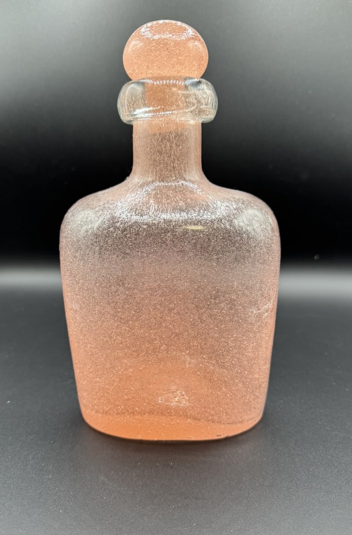 Antique Czechoslovakian Art Glass Decanter: This is a beautifully handblown vintage decanter in a striking frosted pink glass, accented with trapped air bubbles throughout the body. The piece features a substantial, flared rim and a matching gr
