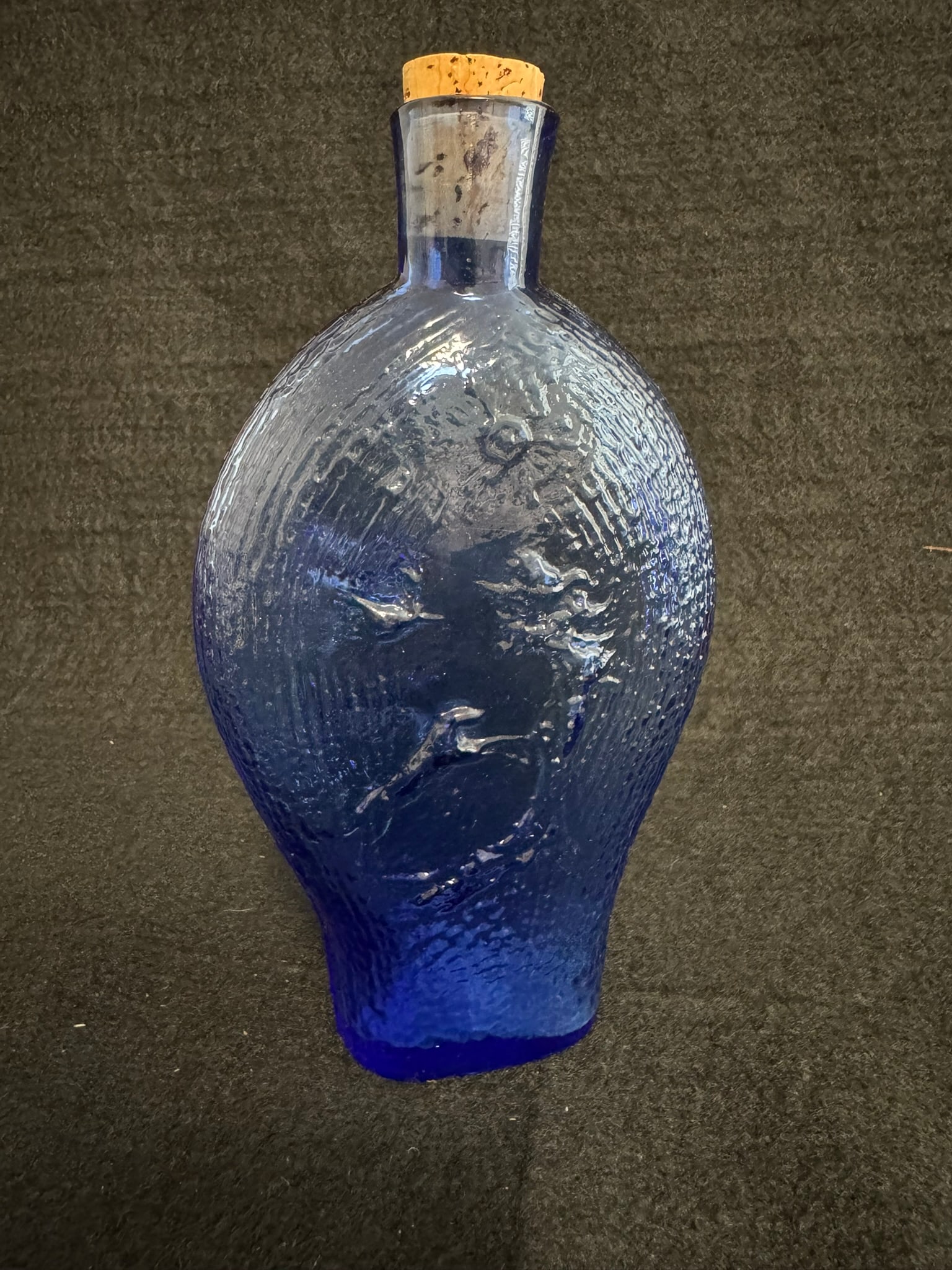 Vintage Cobalt Blue Molded Glass Flask – Baltic Folk Style, Embossed Motif: Vintage Cobalt Blue Molded Glass Flask – Baltic Folk Style, Embossed Motif (8") A decorative cobalt blue molded glass flask with raised imagery on both sides, purchased in the Baltic region. One sid