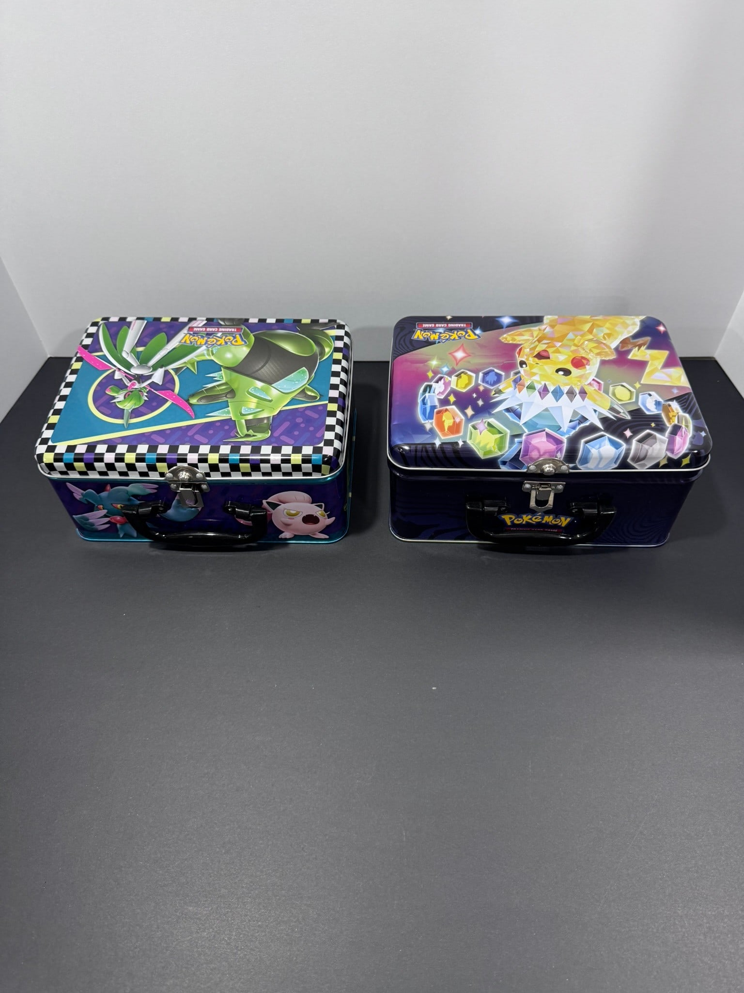 Pokémon Collector Tin & Accessories Lot (2 Tins with Coins, Dice & Deck Boxes): This Pokémon collector lot includes two official Pokémon metal storage tins filled with a variety of trading card game accessories. Contents include multiple Pokémon deck boxes, damage 