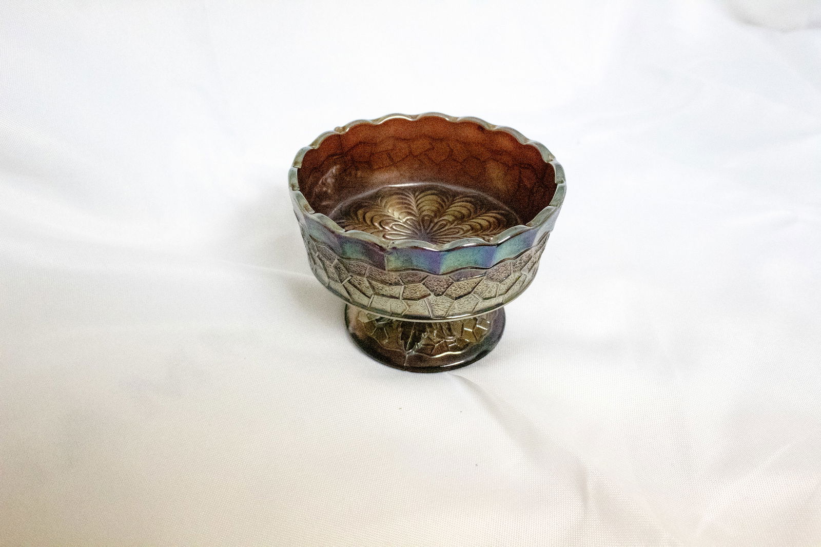 Fenton Vintage Iridescent Carnival Glass Dessert Bowl: Add a touch of vintage charm to your table or collection with this lovely carnival glass dessert bowl. The shimmering finish reflects subtle tones of violet, gold, and aqua, giving the glass a luminou
