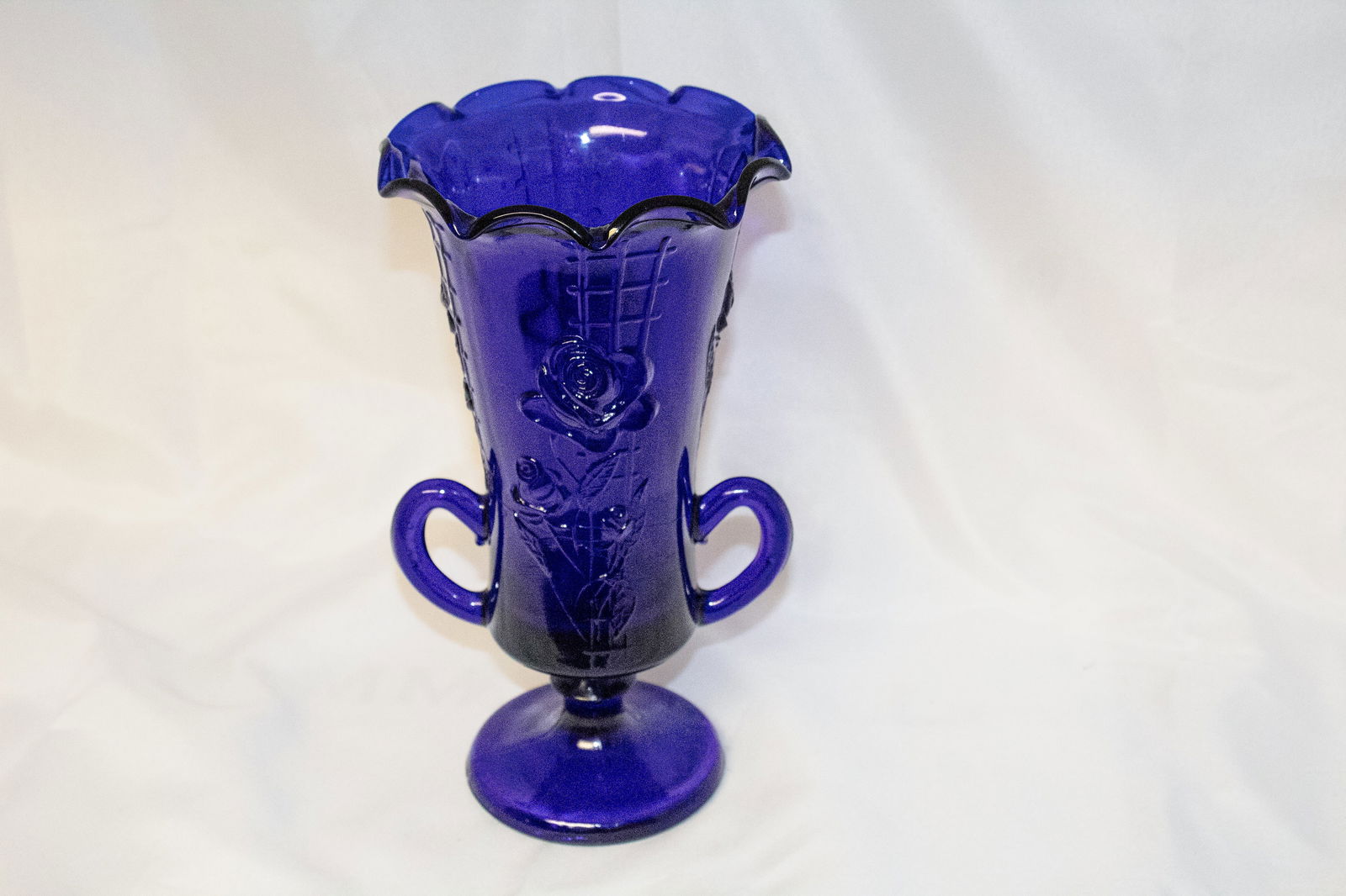 Vintage Cobalt Blue Glass Flower Vase: Elevate your decor with this vintage cobalt blue glass flower vase, known for its vibrant, deep blue color and classic silhouette. Whether used to display fresh blooms or as a standalone piece, this v