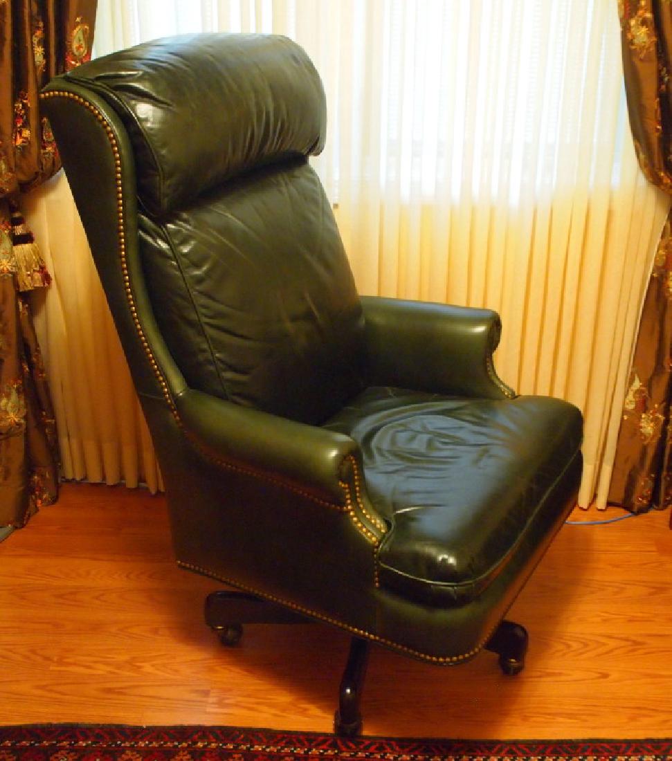 Hancock & Moore leather desk chair: A Hancock & Moore leather upholstered desk chair. Dark green with brass nail head trim, on a swivel base with casters. Light creases and scratches to the leather due to use. 48" high. ESTIMATE $300-50