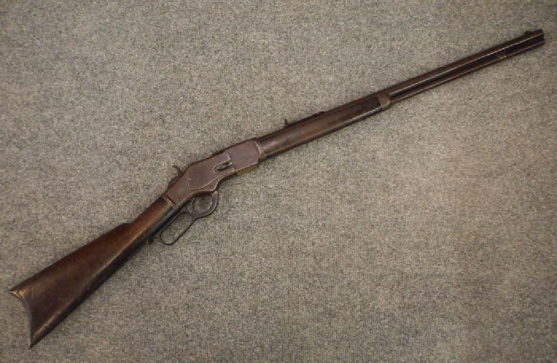 Winchester Model 1873 rifle: A Winchester Model 1873 Rifle. 32 caliber, lever action. Stamped "Winchester's Repeating Arms Co. New Haven, CT., King's Improvement, Mar. 29, 1866, Oct. 16 1860" on the barrel. Serial #213797B. Walnu