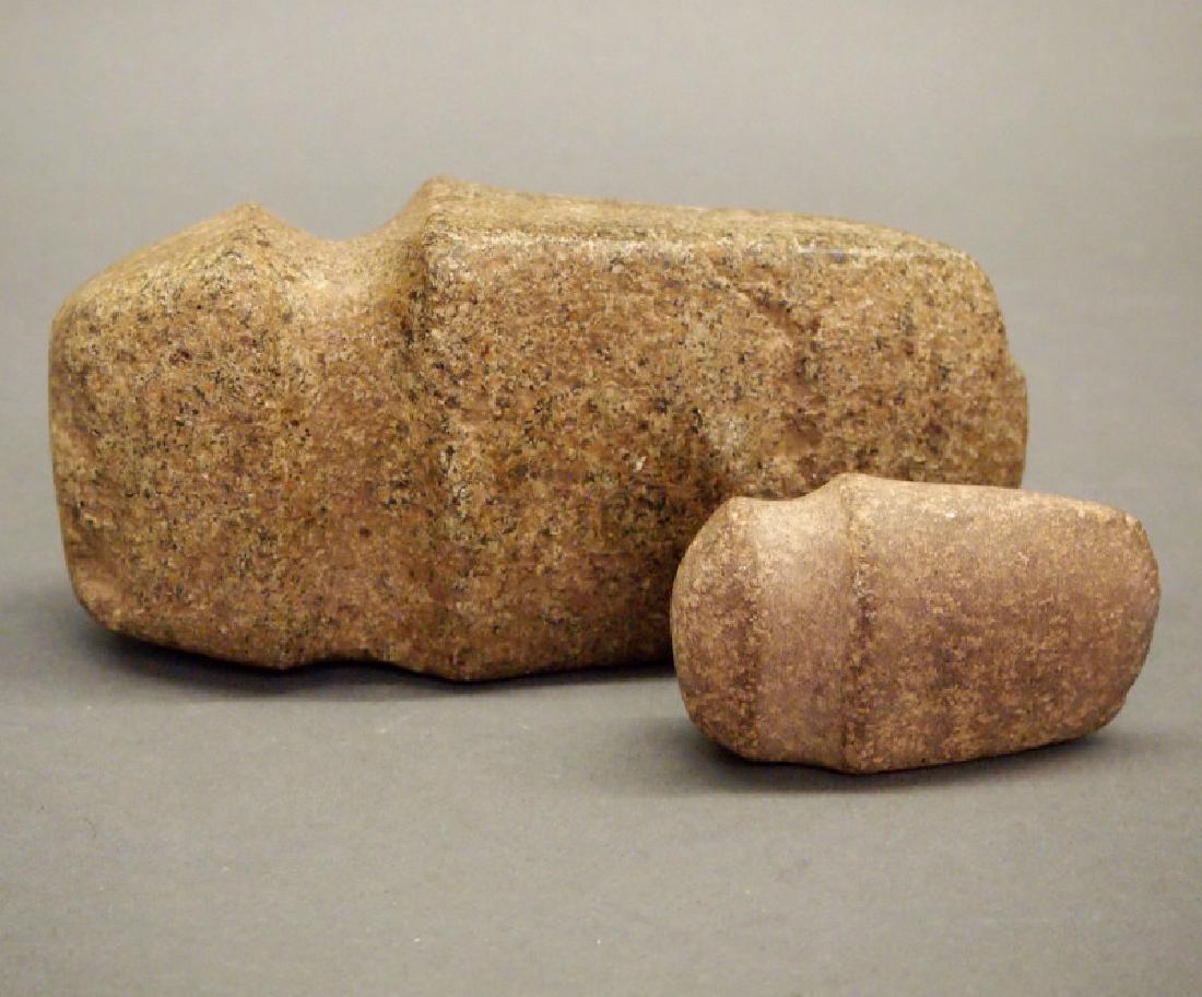 2 3/4 grooved axes: Two Midwest three-quarter grooved axes. Light brown hardstone. Old chip and small nicks to the blades. Largest 3 x 6 1/4" long. ESTIMATE $300-500