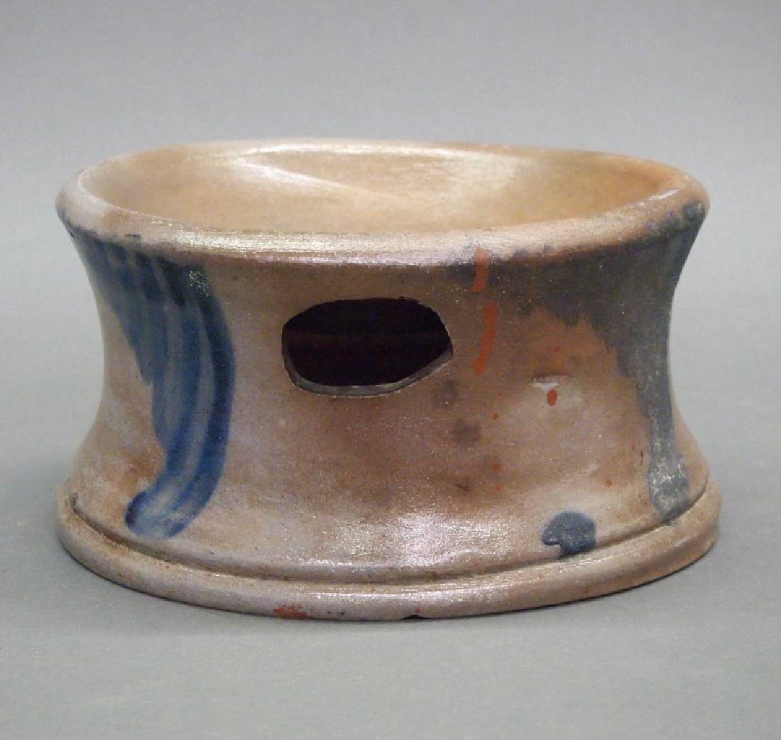 Stoneware spittoon: A mid 19th century stoneware spittoon. Round shape with coved sides decorated in blue with four groups of graduated swags, an oval opening at the shoulder. Unmarked. Similar to an example attributed t