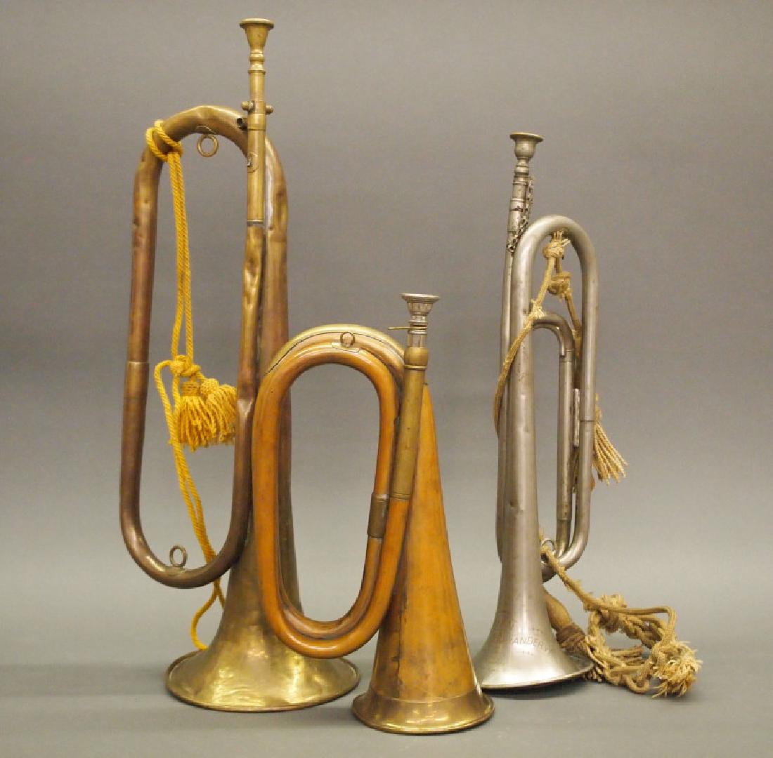 3 antique bugles: Three antique brass bugles. Including 2 copper and brass bugles, unmarked, and 1 white metal Masonic bugle, etched "Adrian Commandery No. 4" on the horn. All have dents of varying degree; the largest 