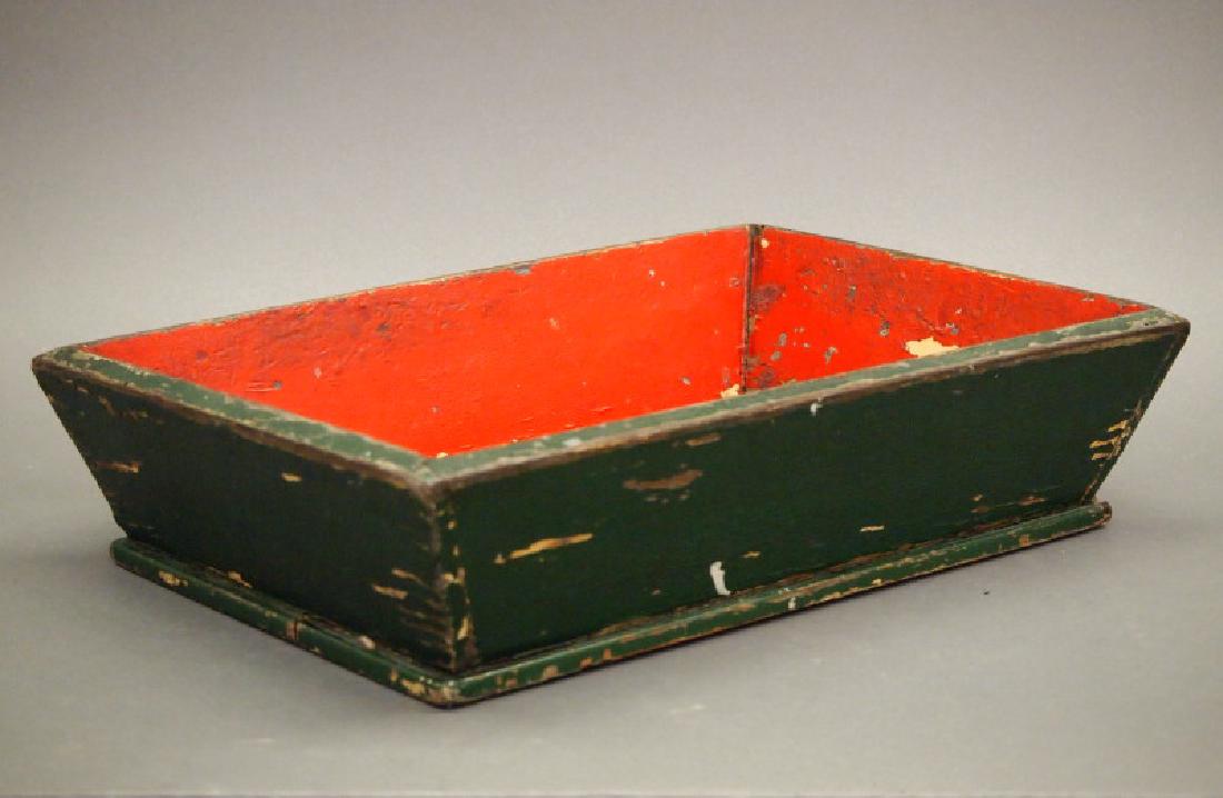 Primitive painted box: A late 19th century Primitive painted wood box. Rectangular, painted red interior and green exterior. Paint is chipping overall. 14 x 3" high. ESTIMATE $100-150