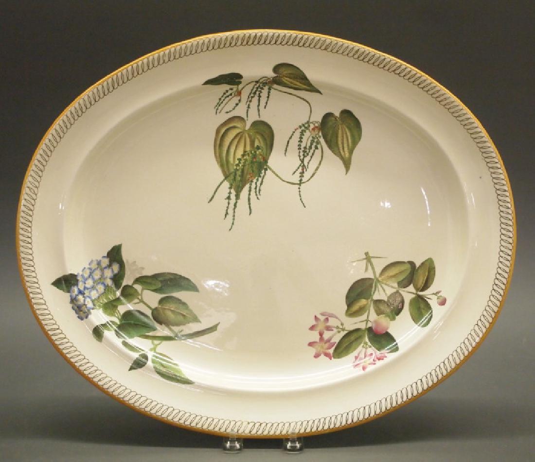 Wedgwood Pearl Ware "Botanical" platter: A mid 19th century Wedgwood Pearl Ware platter. In the "Botanical Flowers" pattern, hand-decorated sprays at the well. Impressed "Wedgwood" and hand numbered A 1602. Light scratches to the well; overa
