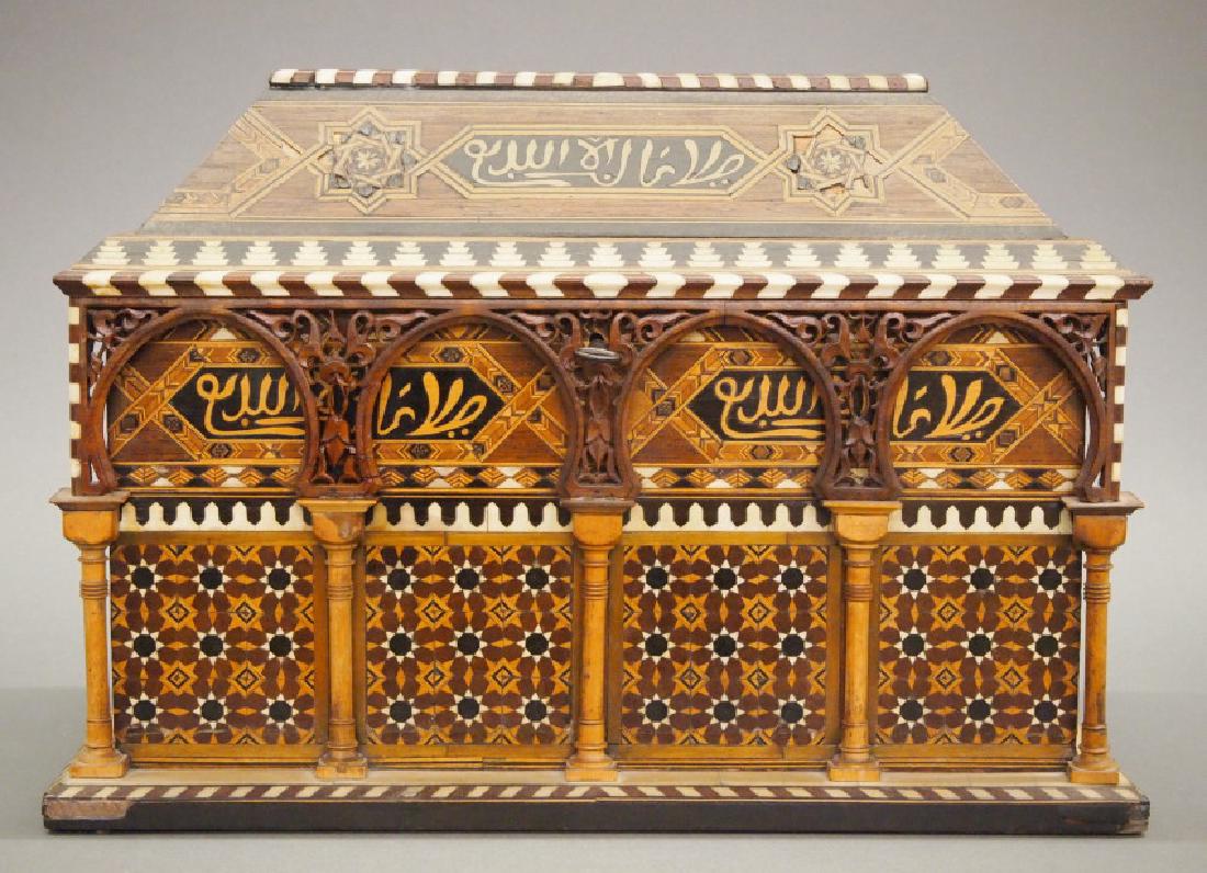 Damascus Inlaid box: A Damascus parquetry and bone box. Rectangular shape with a sloping hinged cover, the exterior features a colonnade with Moorish arches, inlaid overall with Islamic stars, calligraphy, and mosaic. Sig