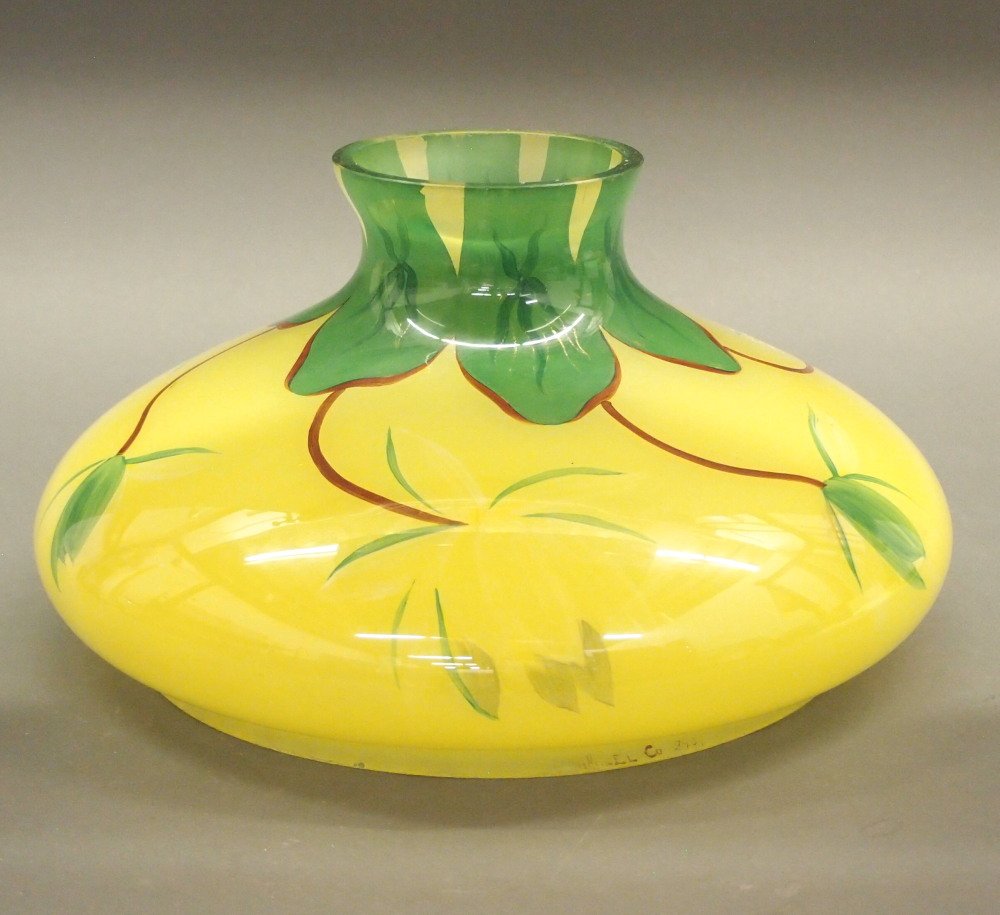 Handel Glass Kerosene Lamp Shade: A Handel Glass Kerosene Lamp Shade. Decorated with tropical flowers of white, red, and green on a lemon yellow ground. Signed "Handel Co. 2401" at the rim. Minor nicks to the fitter. Fitter 10". ESTIM