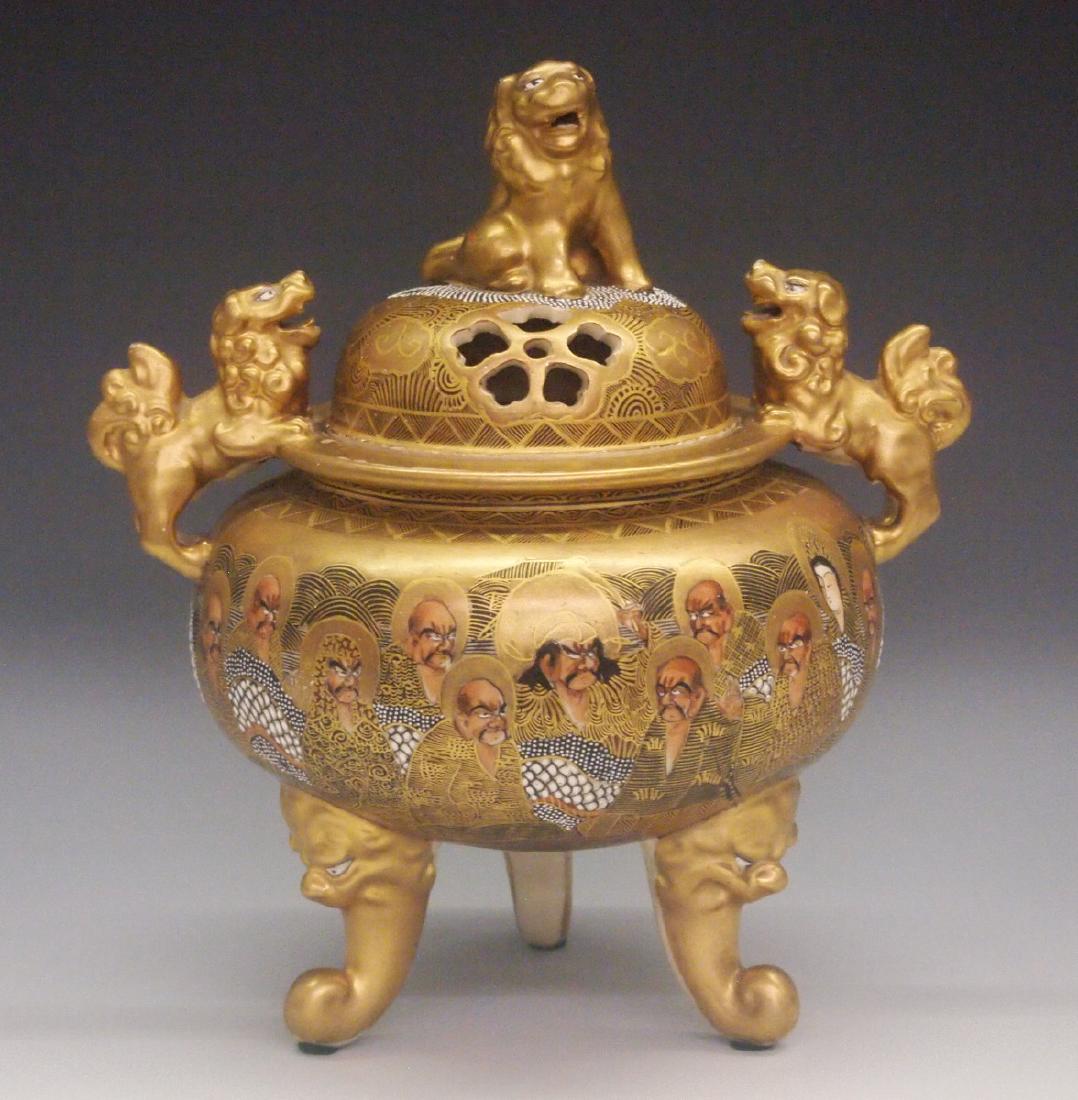Japanese Satsuma Censer: A Japanese Satsuma Censer. Having a pierced cover surmounted by the figure of a foo lion, which is flanked on either side of the shoulder with perched foo lions, and decorated overall with "Thousand F