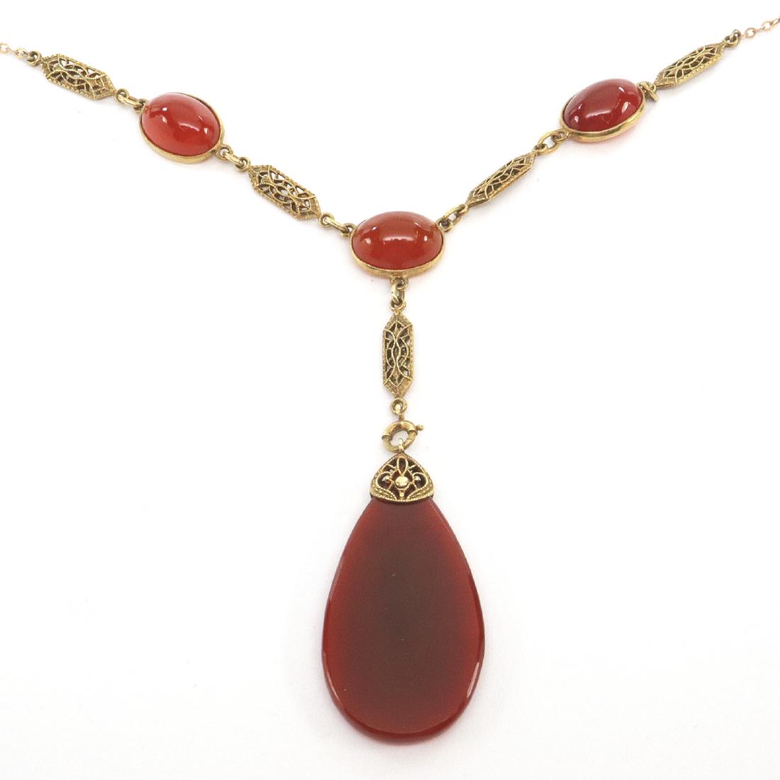 Art Deco Era Carnelian Necklace: An Art Deco Era Carnelian & Gold Necklace. Yellow gold filigree link style necklace with Carnelian cabochons and Pear shape drop. Marked "14K". Minor wear. 12 1/4" long. Totaling approximately 10.8 gr