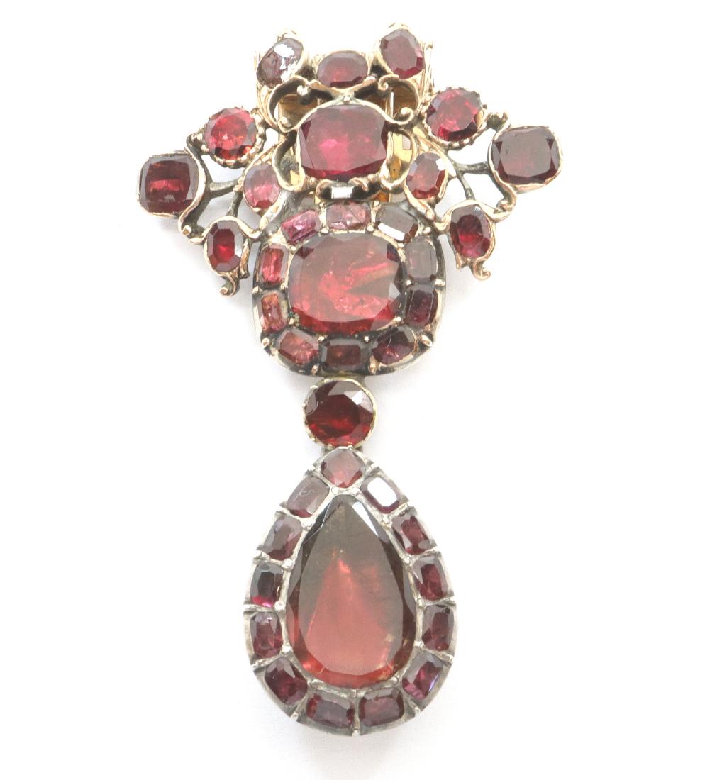 Georgian Modified Dress Clip: A Georgian Modified Dress Clip. With purplish-red foil back stones set in sterling with a 14 kt yellow gold clip. As mentioned, the piece has been modified and the clip is of a later date; wear overal