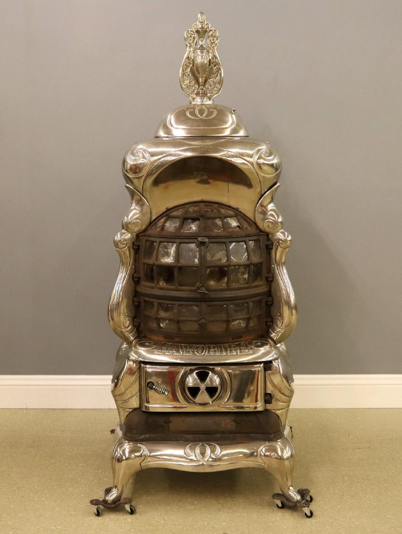 Favorite "No. 61" Parlor stove: A turn of the century Favorite "No. 61" Parlor Stove. Cast iron and nickel plated stove with isinglass panels on three sides. Minor surface wear, some damaged glass, lacks interior grate, crack at bas