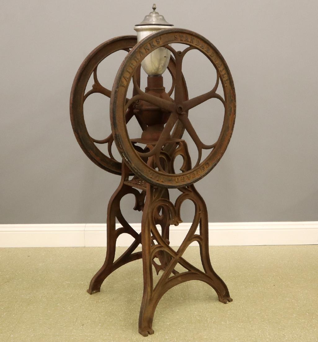 Fairbanks Floor Model Coffee Mill: A 19th century Fairbanks Coffee Mill. Painted cast iron floor model coffee mill, marked "Fairbanks Standard Mill Chicago Ill.". Replaced metal cover and hopper which show some indentations, lacks hand