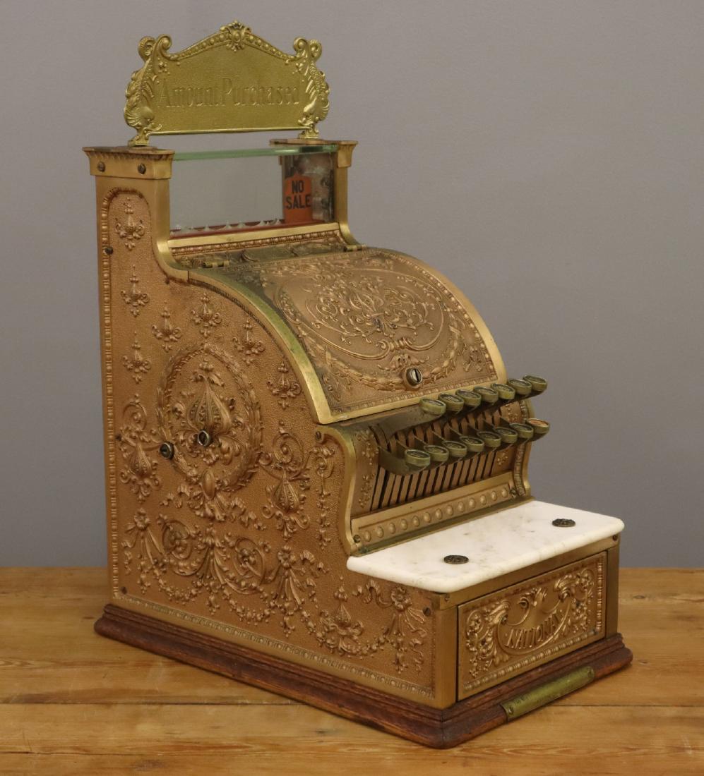 National Cash Register, Model 313: A 1912 NCR Model 313 Brass Candy Store Cash Register. Wear and minor damage, replaced marquee. 21 3/4" high overall. ESTIMATE $200-400