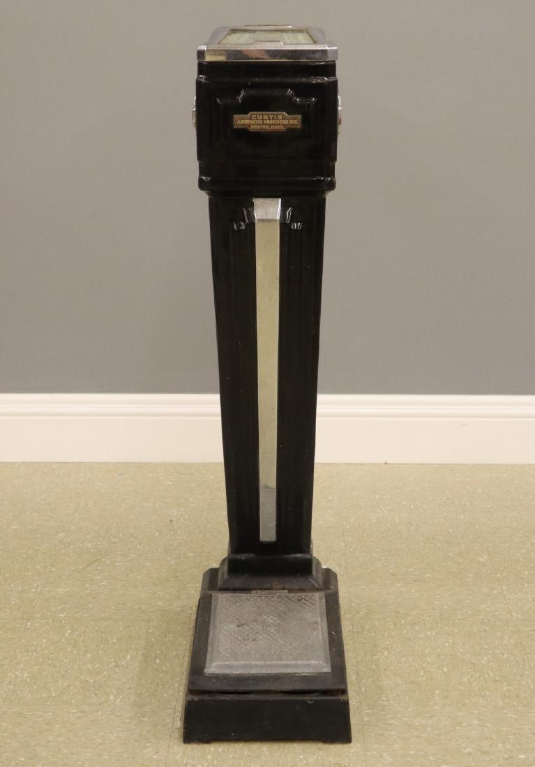 Curtis Automatic Products Inc. Penny Scale: A 1930's Curtis Art Deco Penny scale. Old worn finish. 43 3/4" high. ESTIMATE $100-200