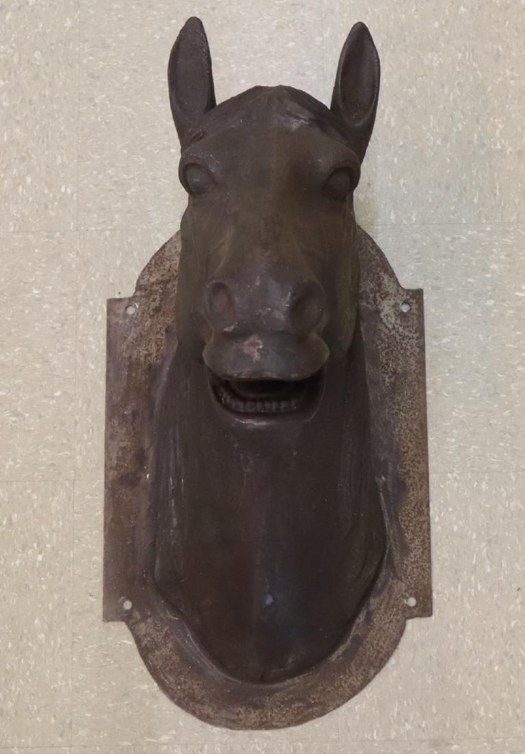 Cast Iron Horse Head: Reproduction French Cast Iron Butcher shop sign. Horse head form with a shaped backplate. Natural surface with some corrosion. Approx. 30" high x 22" deep overall. ESTIMATE $200-400
